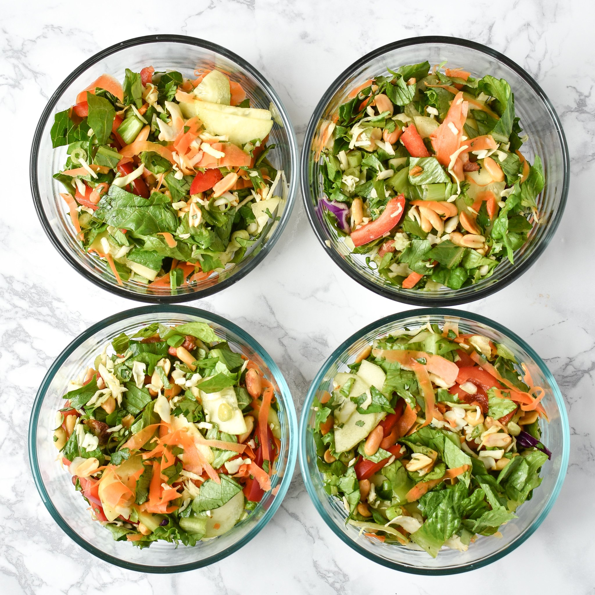 meal prep chopped thai salad in four glass pyrex bowls