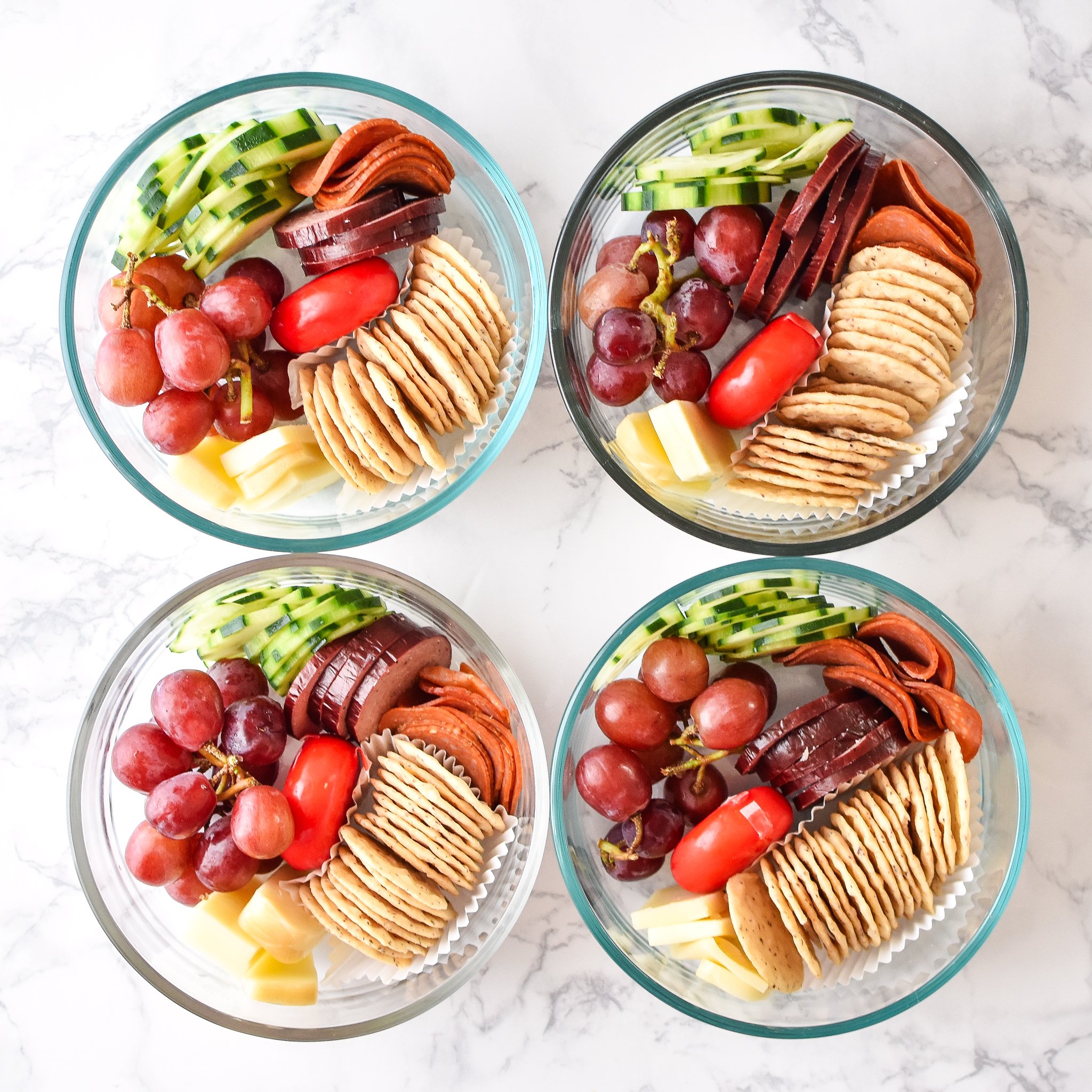 How to Turn Cheese and Crackers into DIY Adult Lunchables - 4 meal prepped lunchables viewed from above