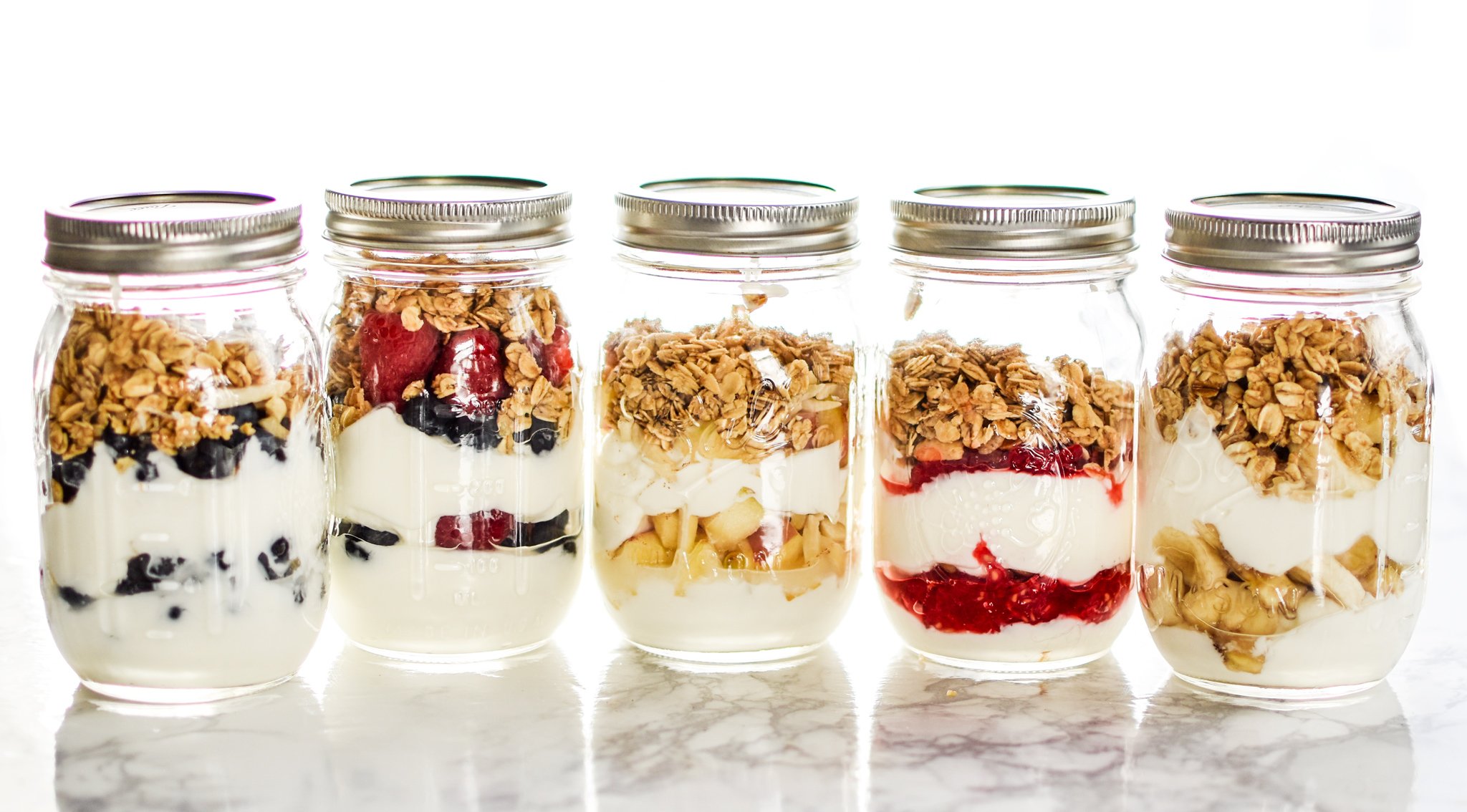 5 Make-Ahead Fruit & Greek Yogurt Parfait Ideas to Try for Breakfast - Greek yogurt with just a hint of sweetness, layered with fruits and topped with granola, 5 WAYS!! Prep ahead and grab it on your way out the door tomorrow! - ProjectMealPlan.com