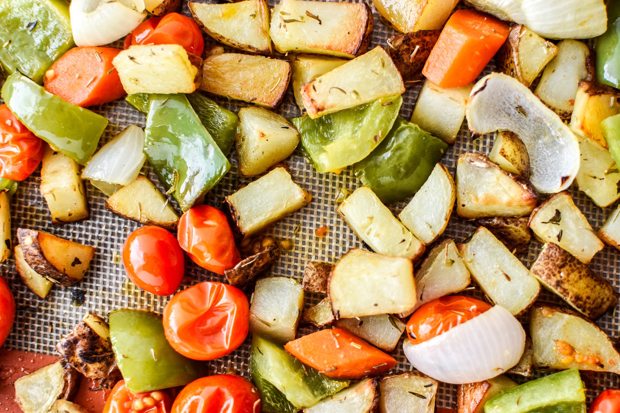 Simple, healthy, Meal Prep Italian Seasoned Chicken with Roasted Imperfect Vegetables including potatoes, cherry tomatoes, onions, and bell peppers!