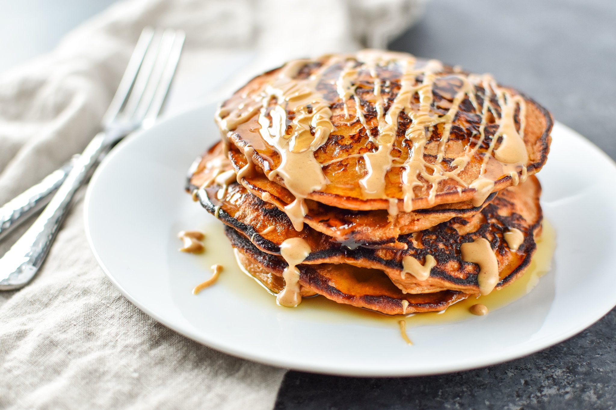 5-Ingredient Sweet Potato Banana Pancakes - Banana, sweet potato, nut butter, eggs and cinnamon are all you need to make these simple pancakes happen. - ProjectMealPlan.com
