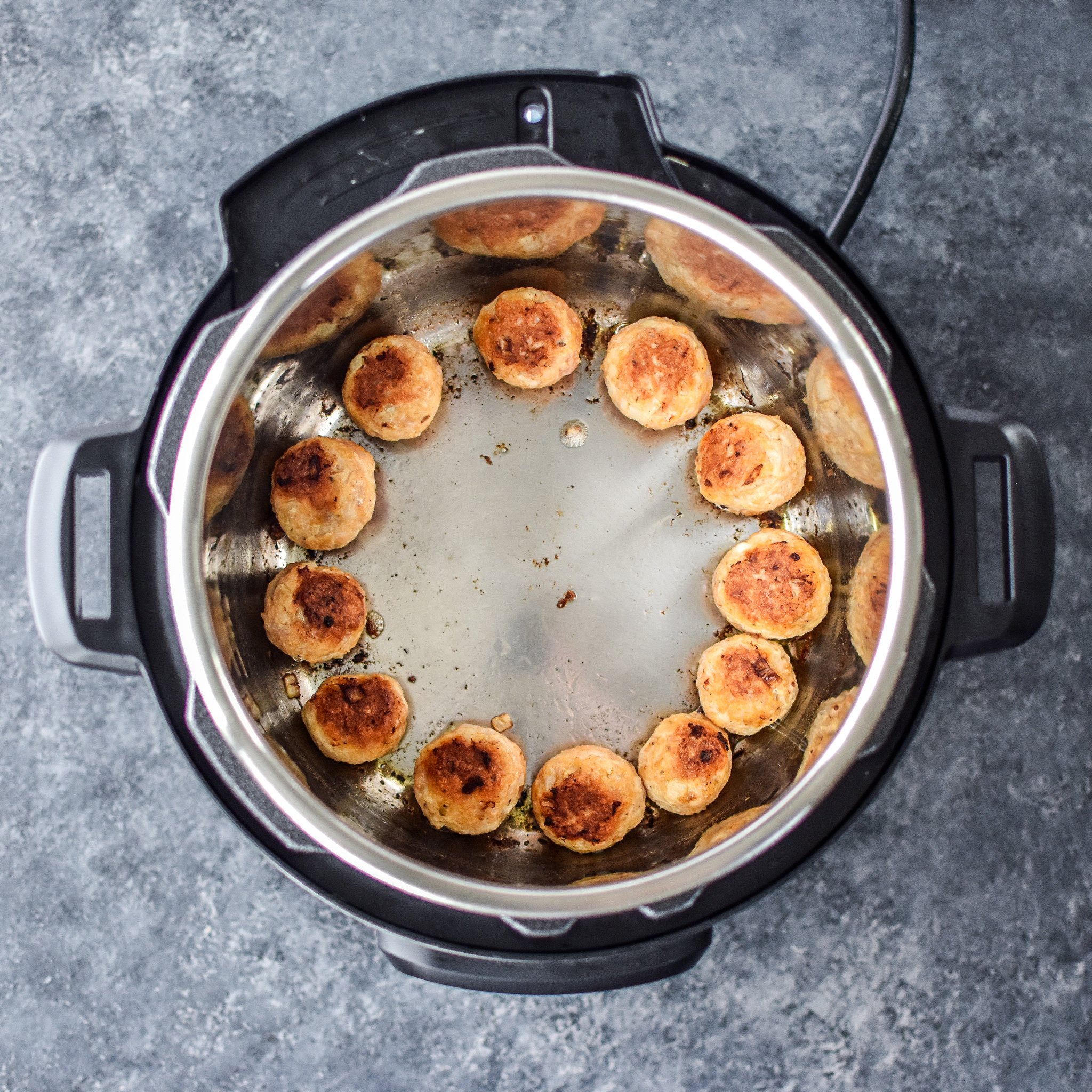 Chicken meatballs browning in an Instant Pot.