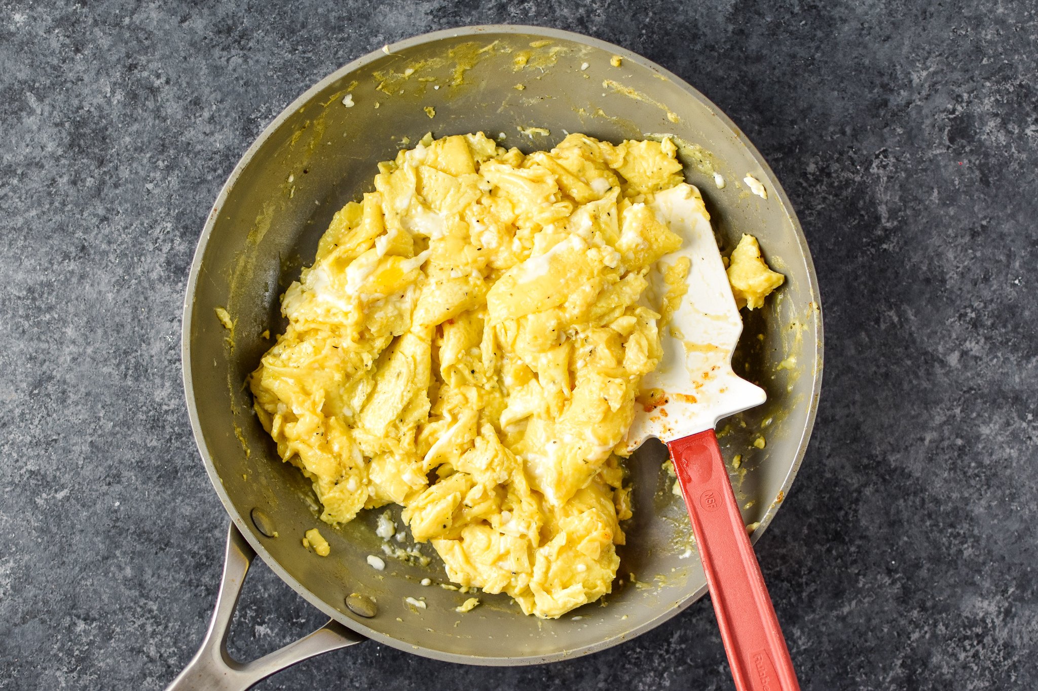 A pan of fresh scrambled eggs, top view.