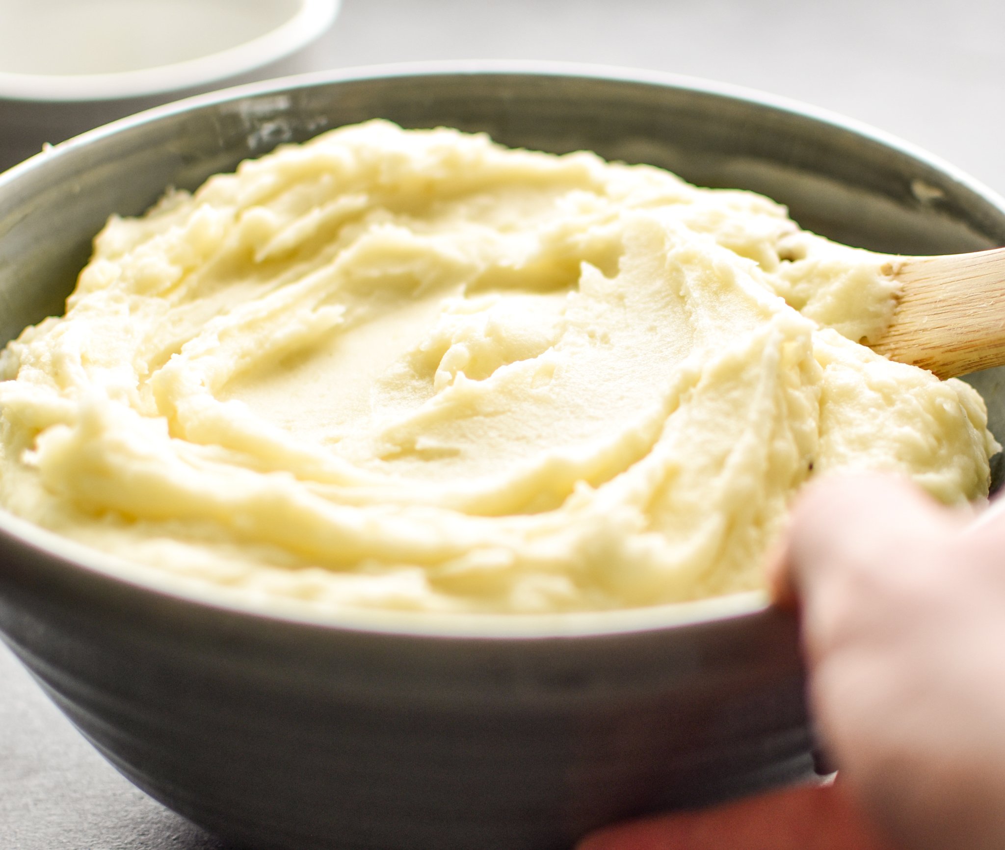 A bowl of 3-Ingredient Mashed Potatoes ready to be eaten with dinner.