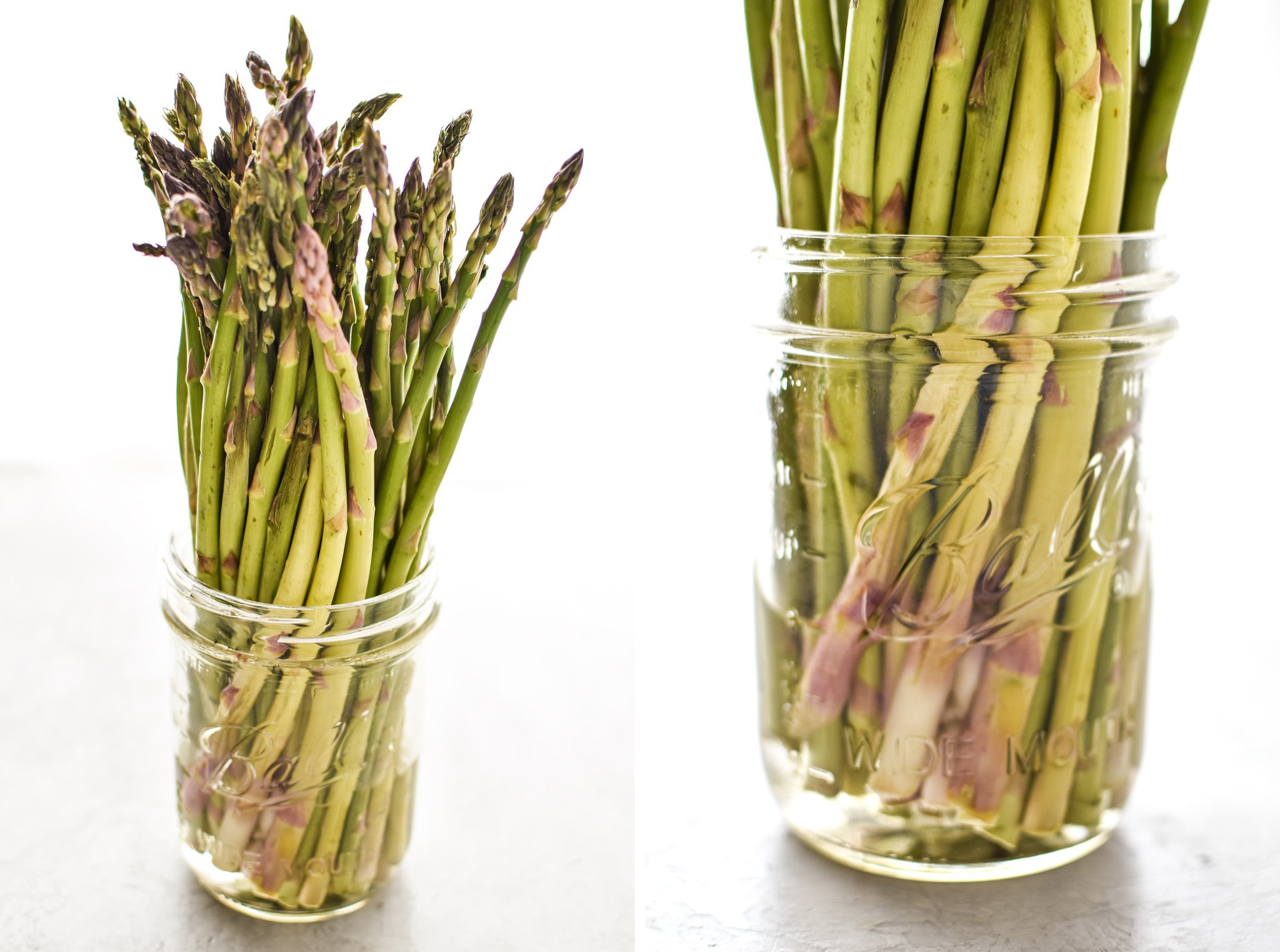 Asparagus spears in some water in a mason jar to keep them fresh.