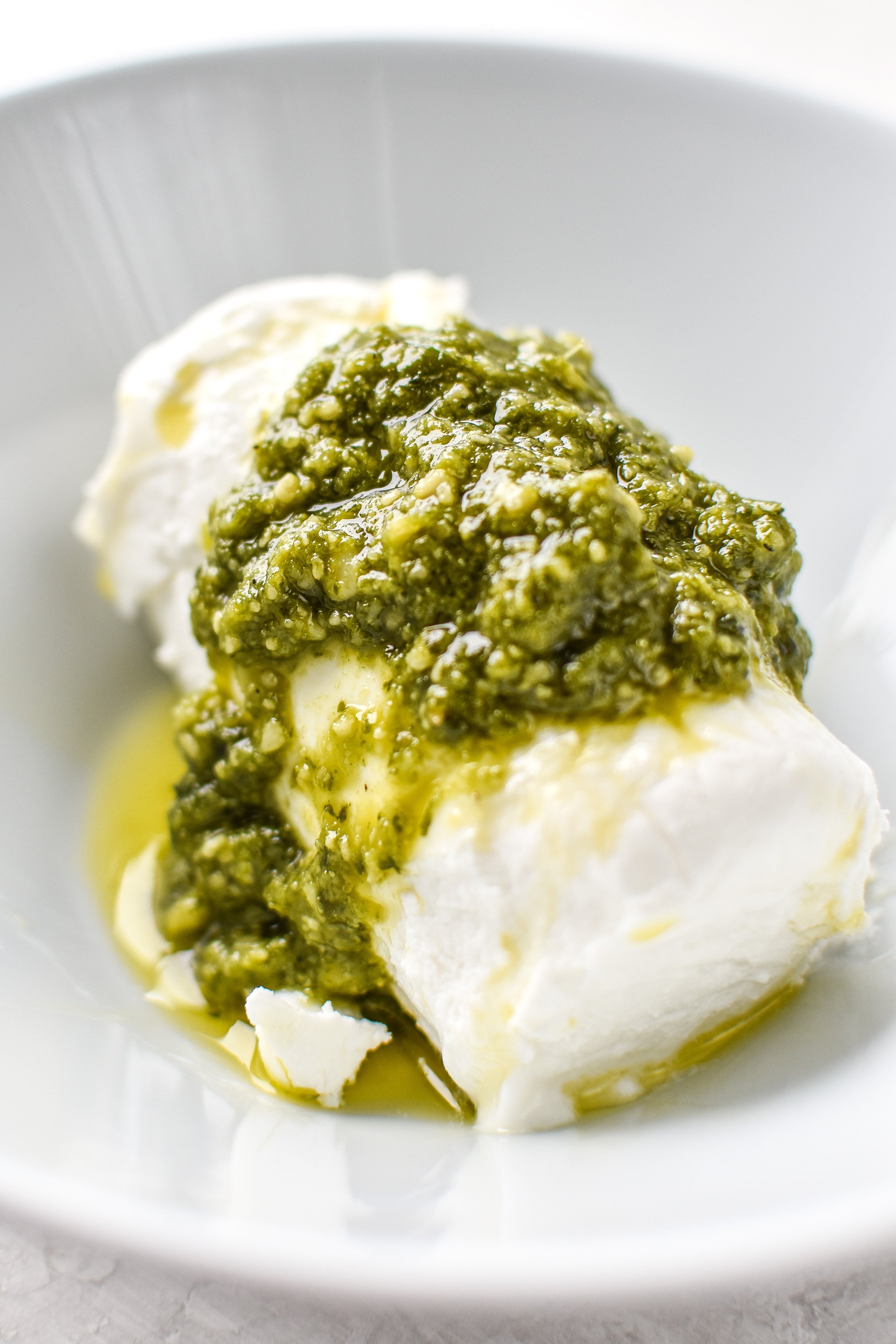 Ingredients for the 3 ingredient Pesto Goat Cheese Dip in a bowl before mixing.