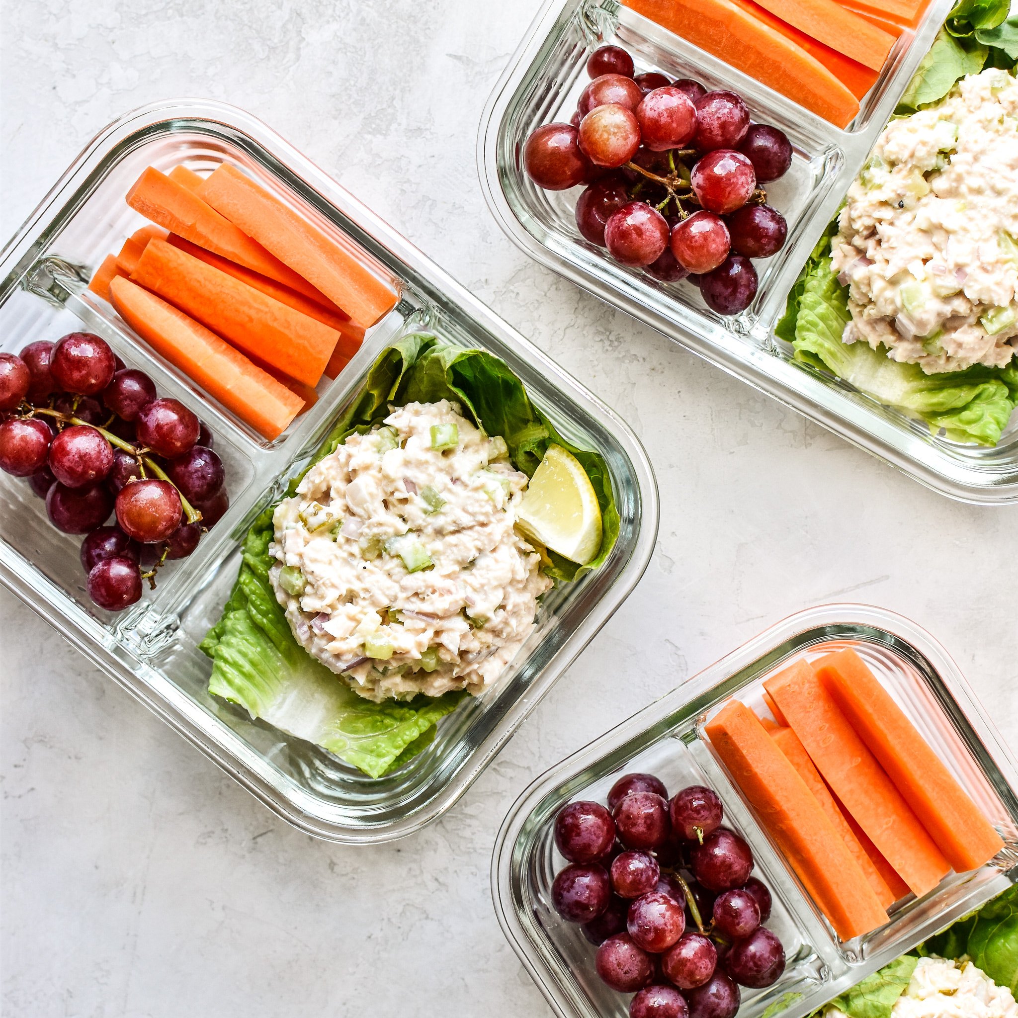 Tuna salad meal prep with grapes and carrots in meal prep containers.