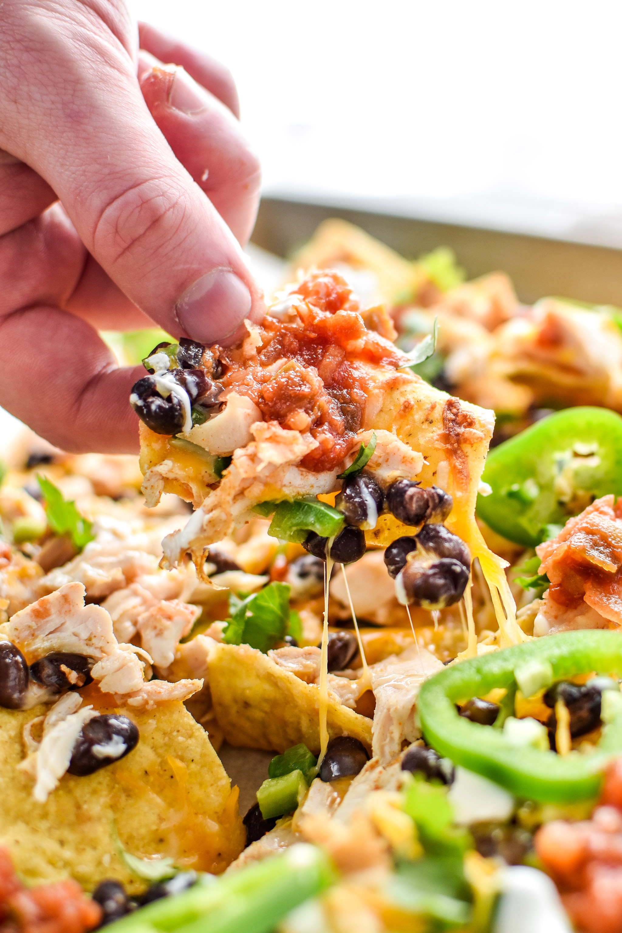 Taking a chip from the prep ahead rotisserie chicken nachos sheet pan. Yummy!
