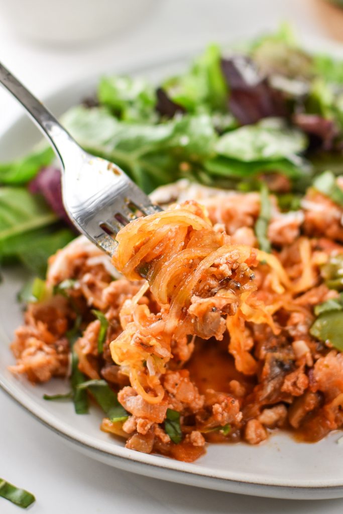 close up of spaghetti squash spaghetti bake on a fork.