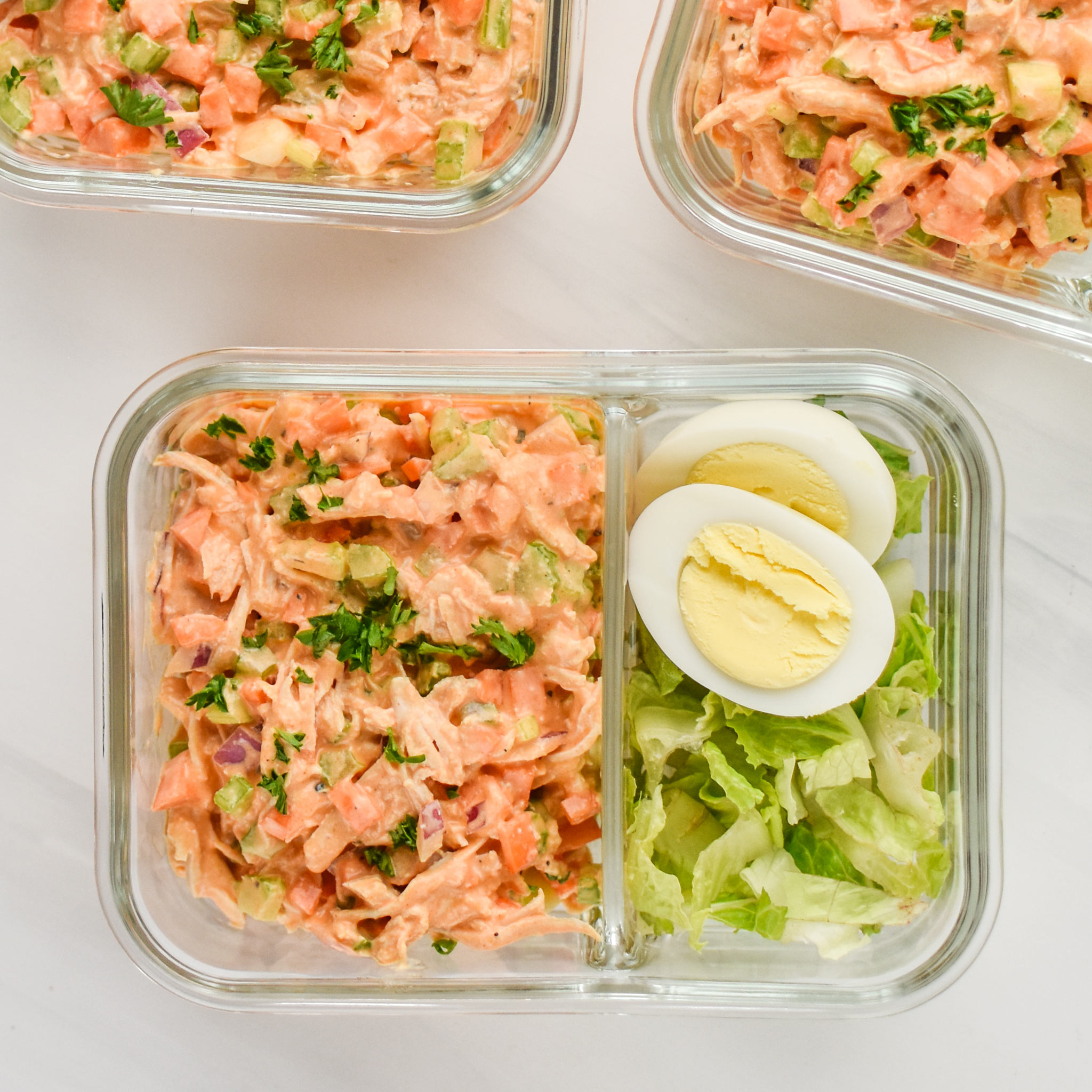 Easy Buffalo Chicken Salad meal prepped with a hard boiled egg and chopped romaine
