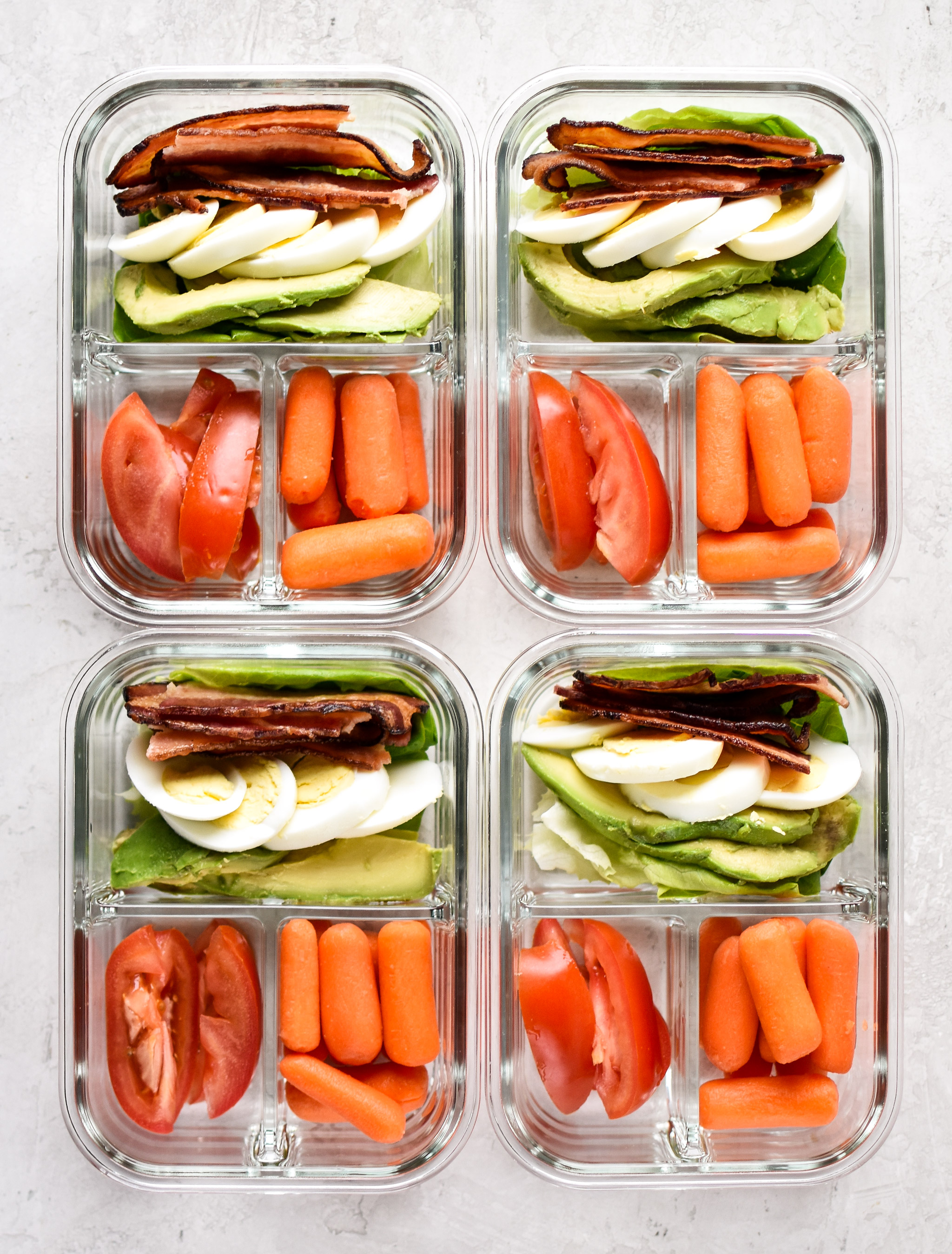 BLTA Lettuce Wraps Meal Prep pictured in 4 meal prep containers from above with baby carrots.