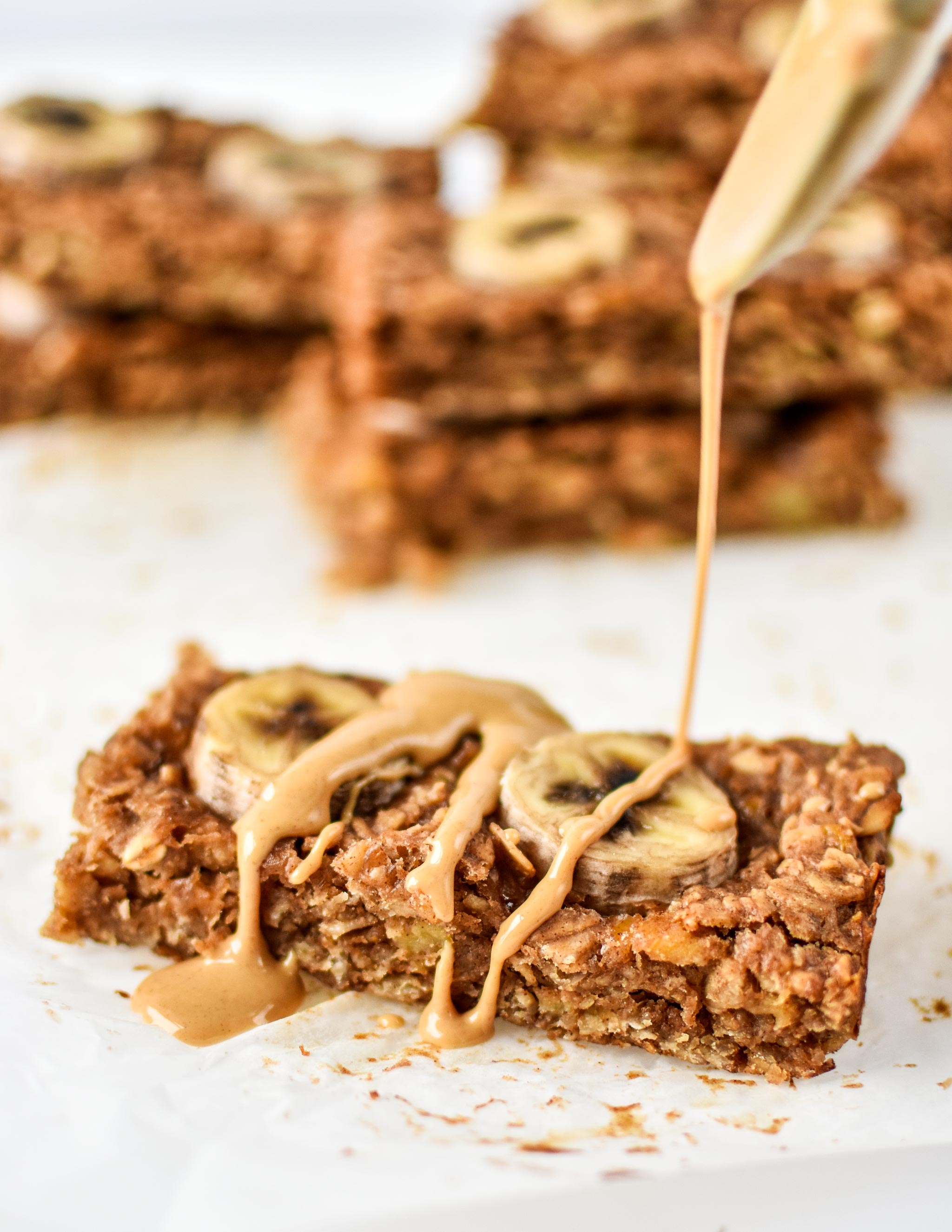PB Banana Oatmeal Breakfast Bars drizzled with peanut butter