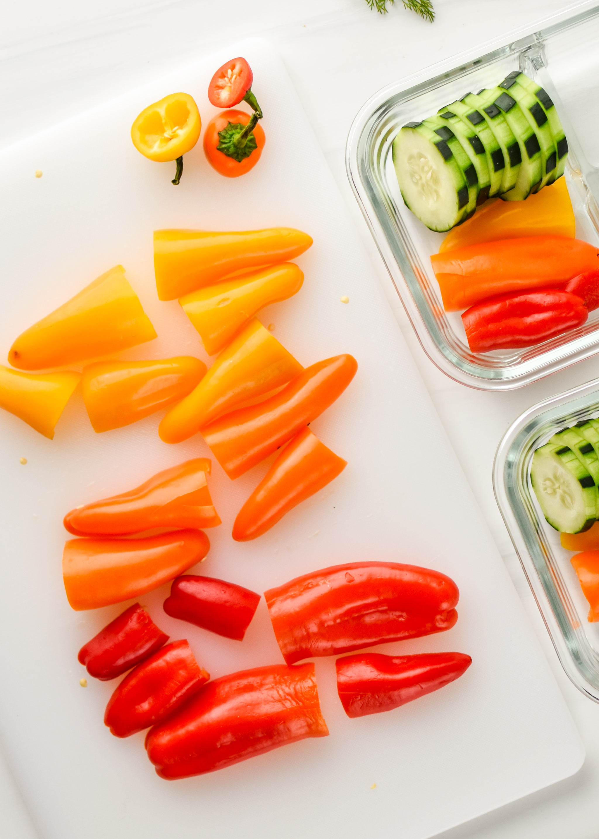 Rainbow mini peppers being cut up for the herbed goat cheese rainbow snack boxes.