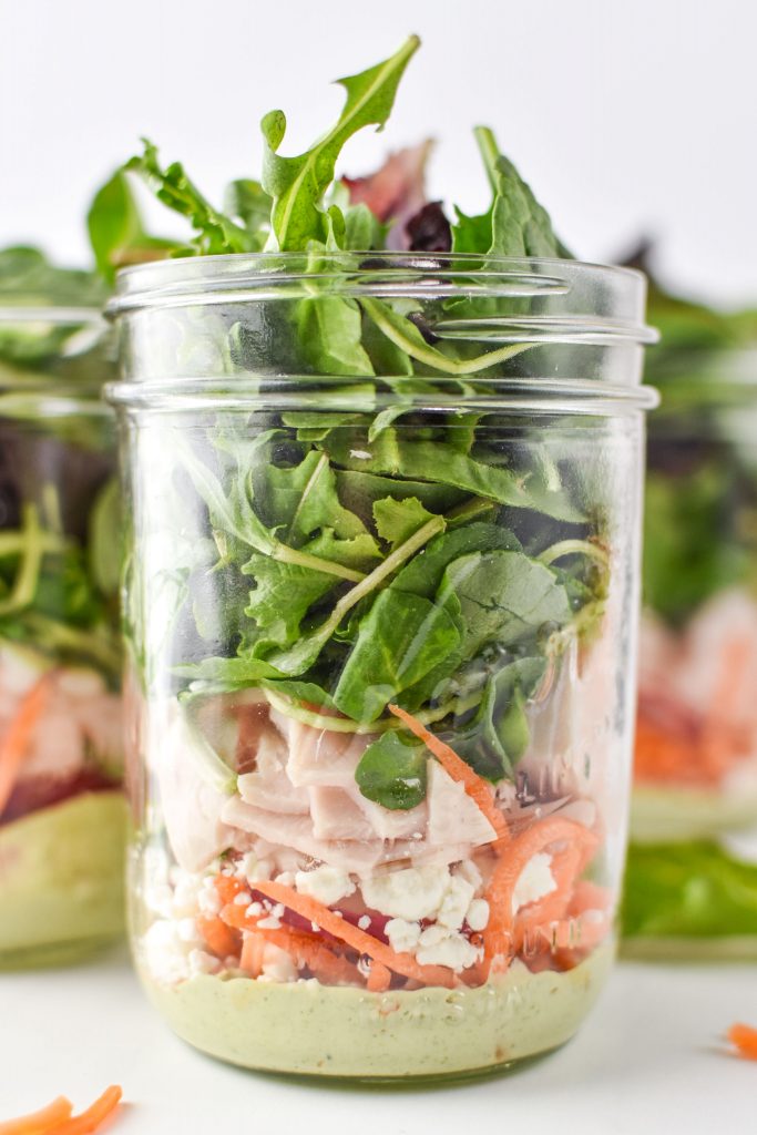 mason jar salad with dressing at the bottom.