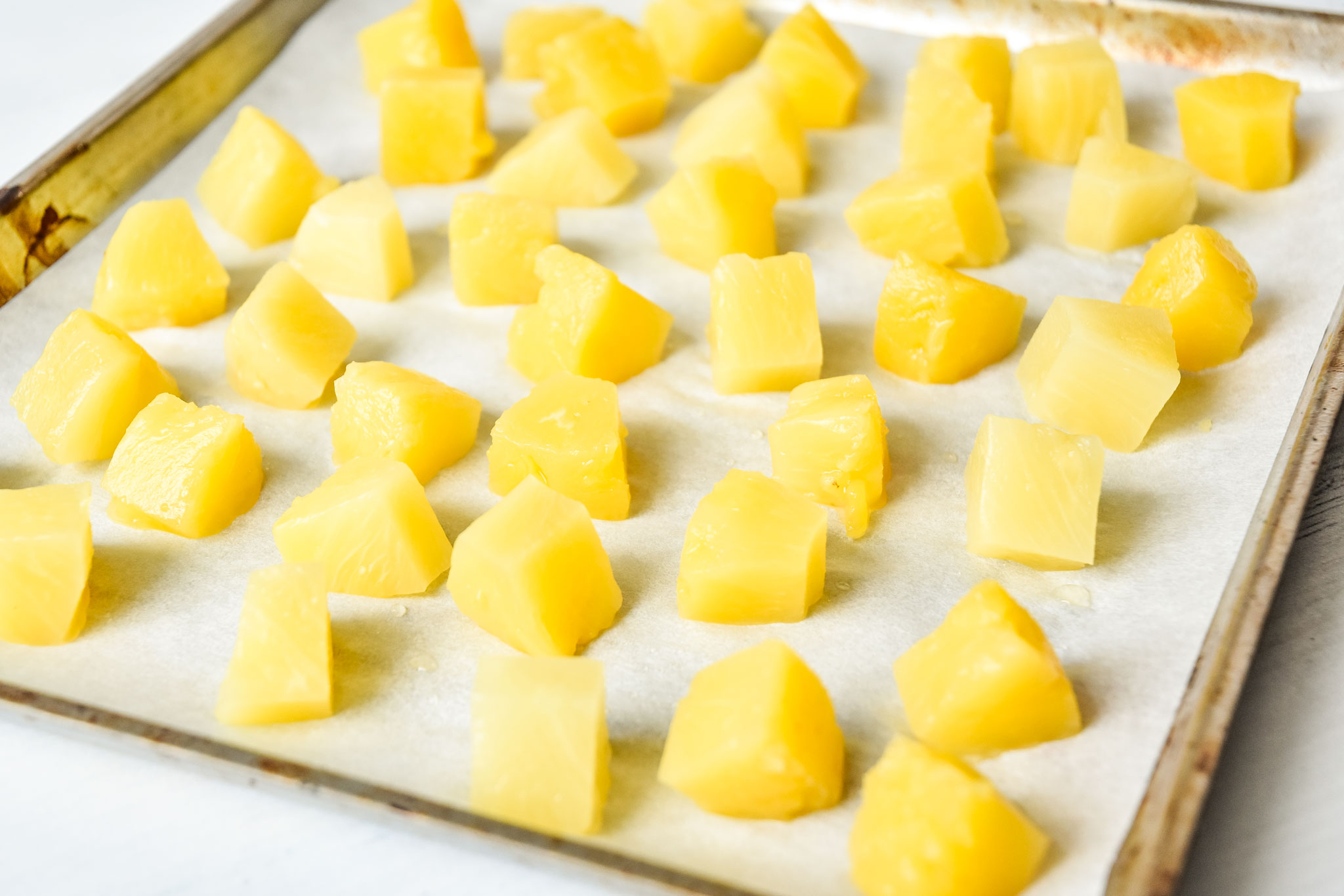 sheet pan of pineapple chunks to be frozen for summer white wine sangria