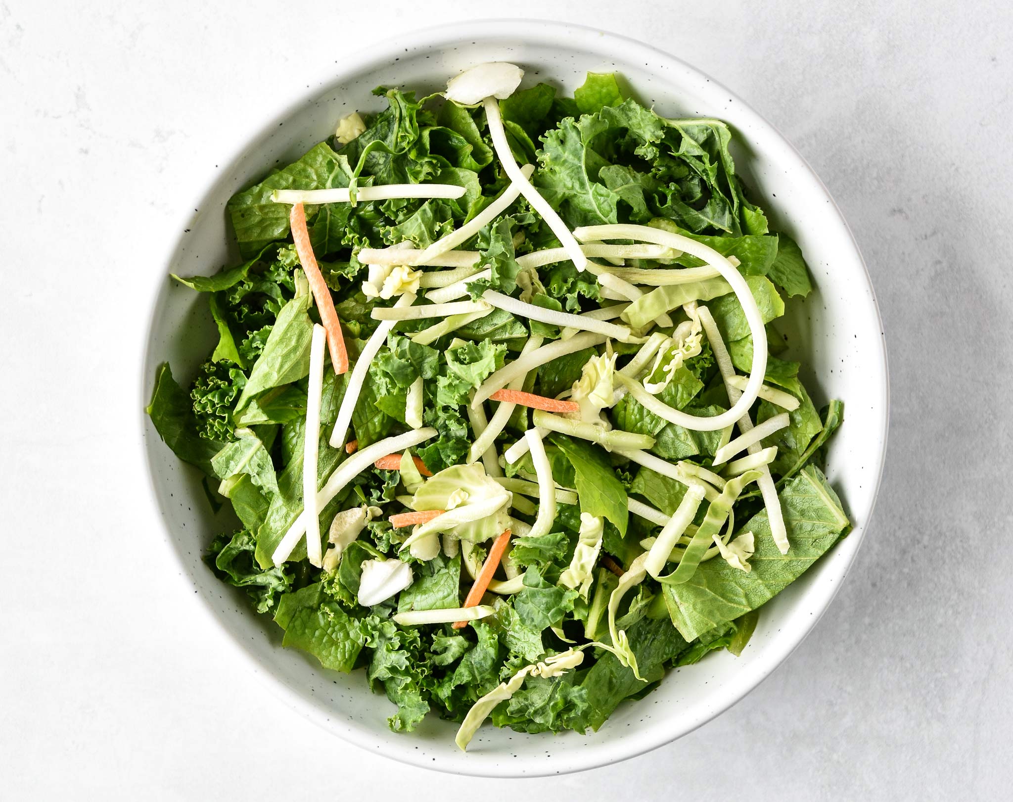 kale salad with some cabbage brussel sprout slaw on top