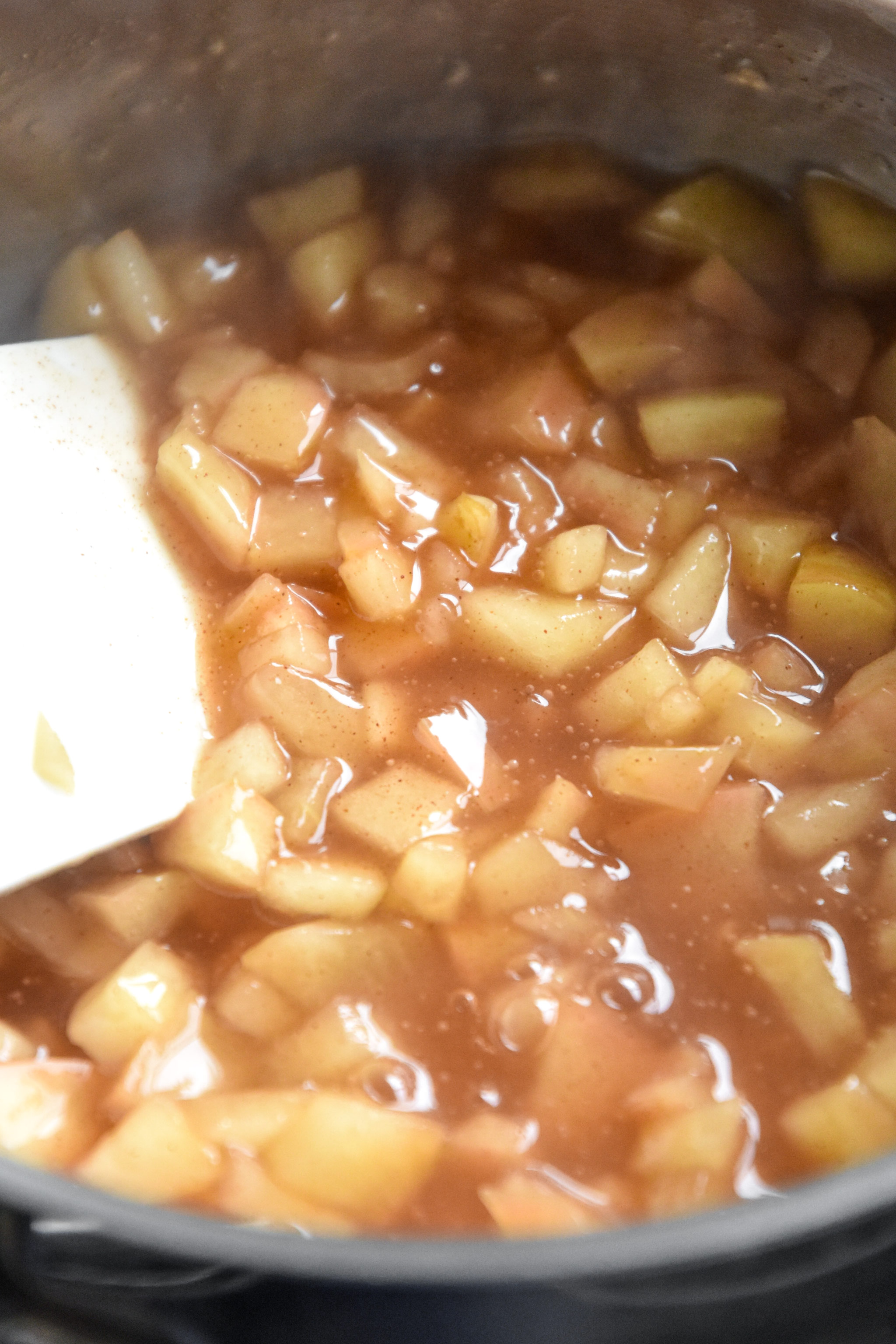 apples and cinnamon cooked in a small saucepan