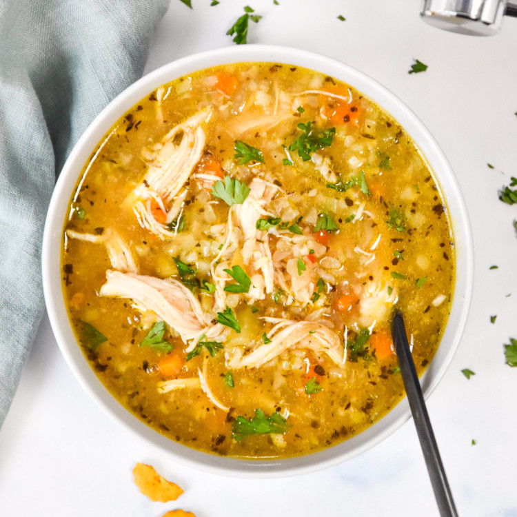 instant pot ginger chicken & rice soup in a bowl with a spoon