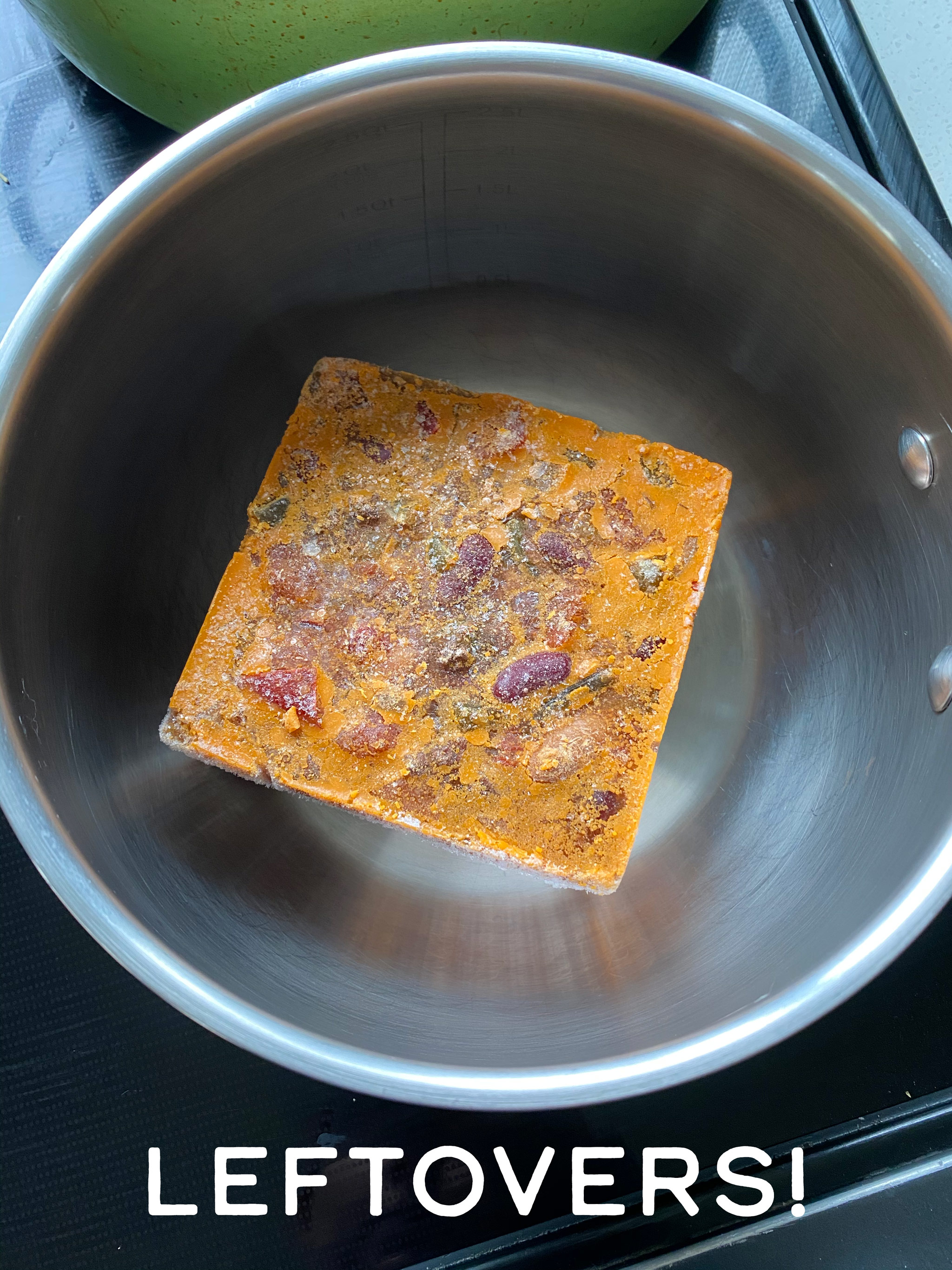 a cube of frozen chili in a pan.