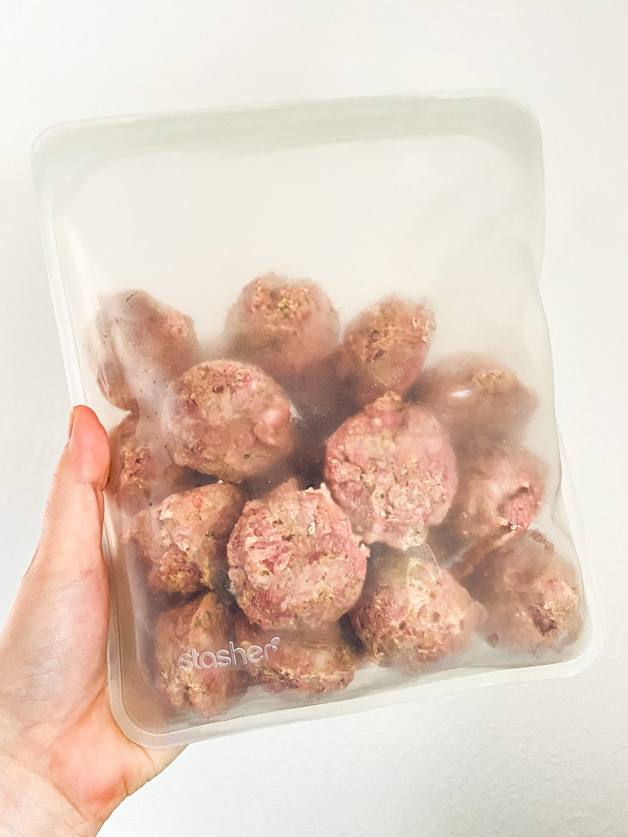 frozen meatballs transferred to a stasher bag freezer safe container.