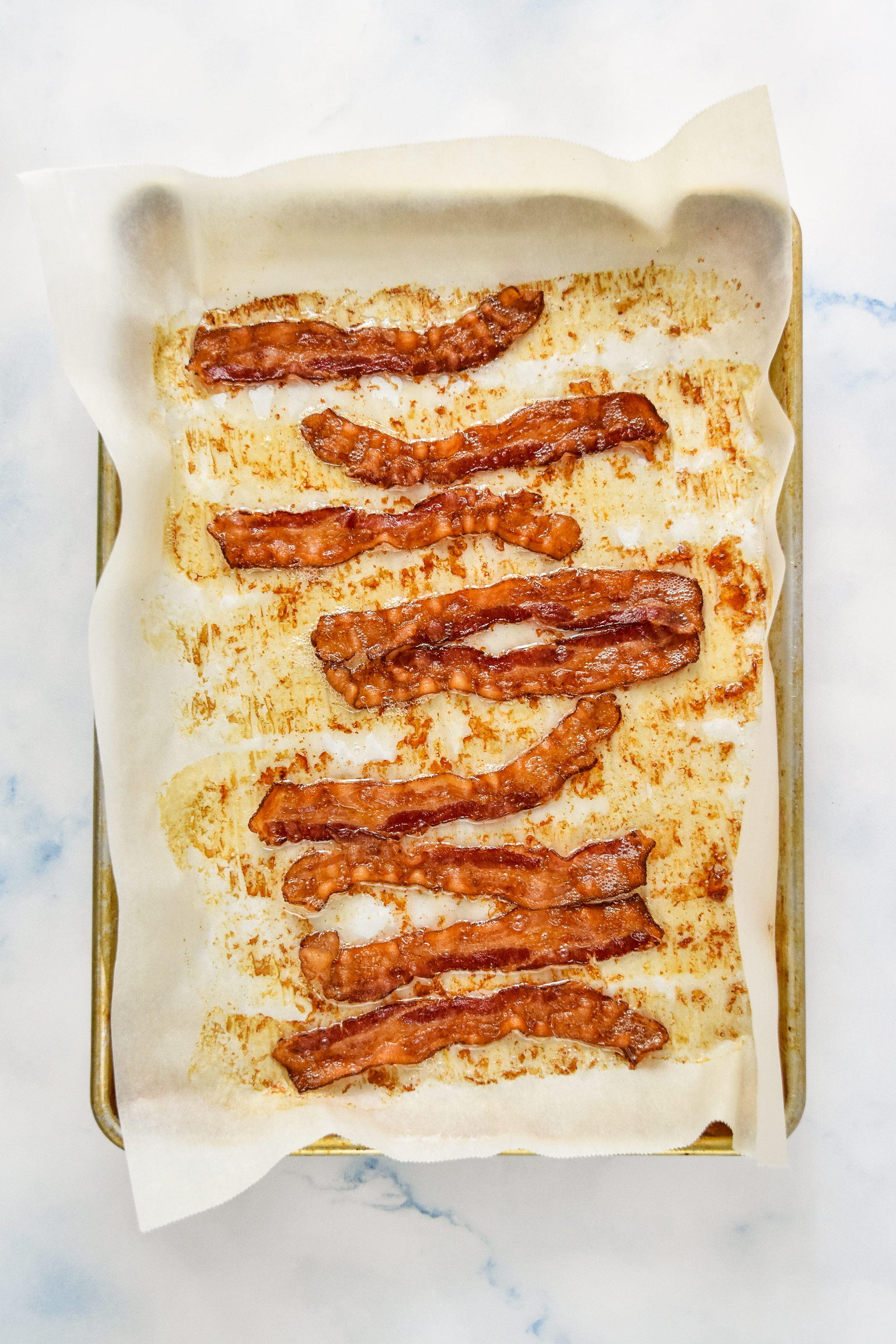 oven baked bacon on parchment paper.