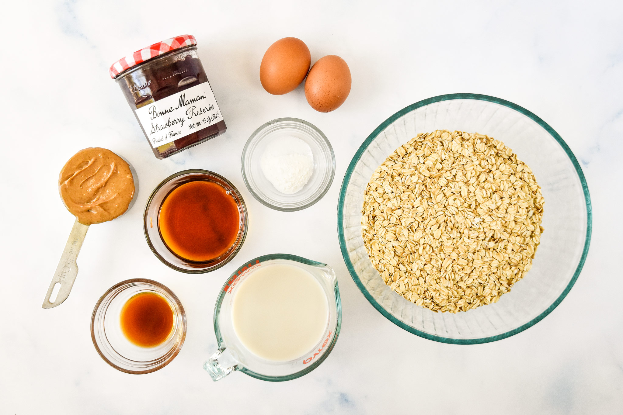 ingredients on a counter top for the pbj baked oatmeal cups.