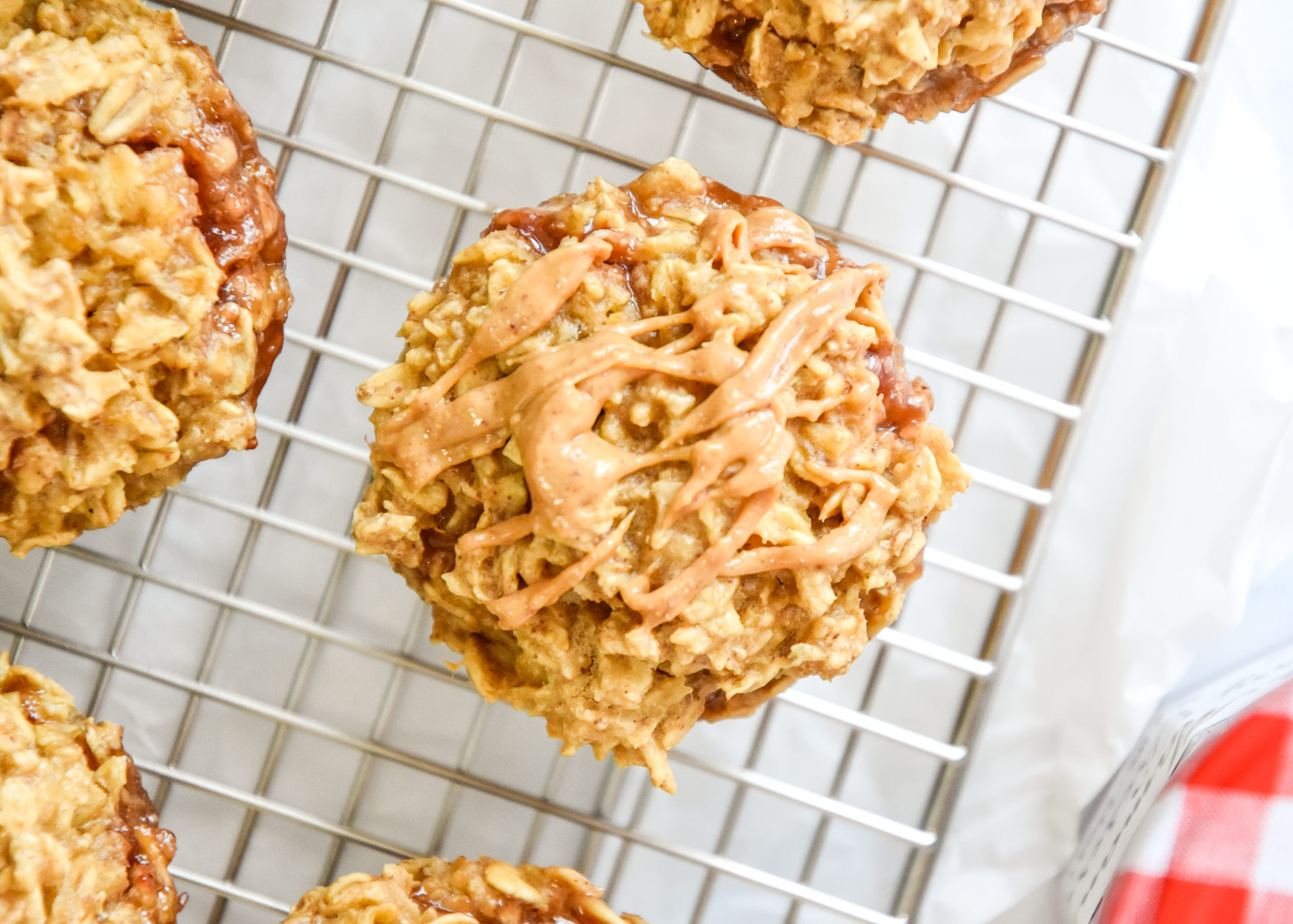baked oatmeal cup on a cooling rack with peanut butter on top.