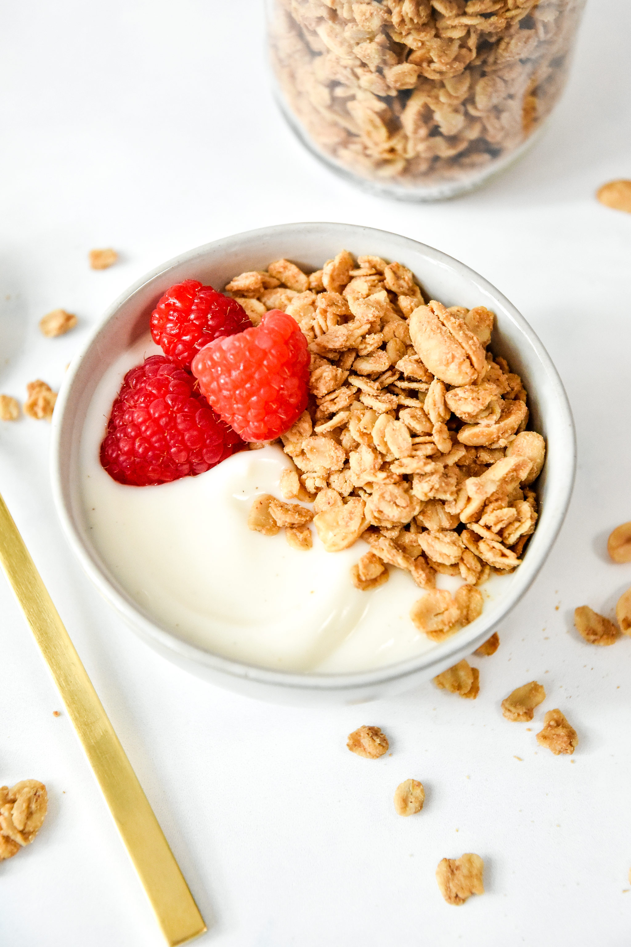 easy peanut butter granola on yogurt with raspberries.