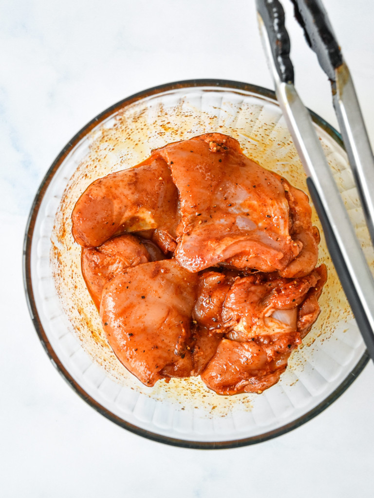 seasoned chicken thighs in a bowl for the air fryer boneless bbq chicken thighs.
