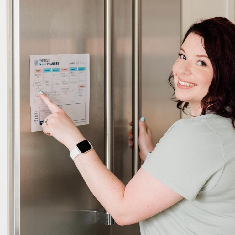pointing to meal plan on fridge.