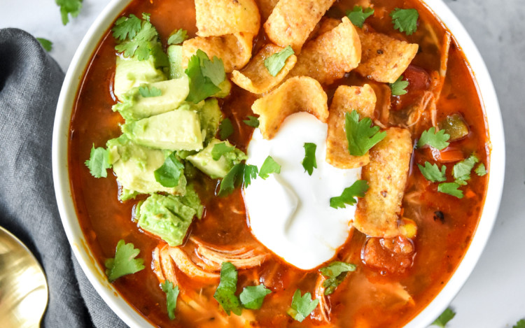 bowl of instant pot no bean chicken chili with sour cream, avocado and corn chips on top.