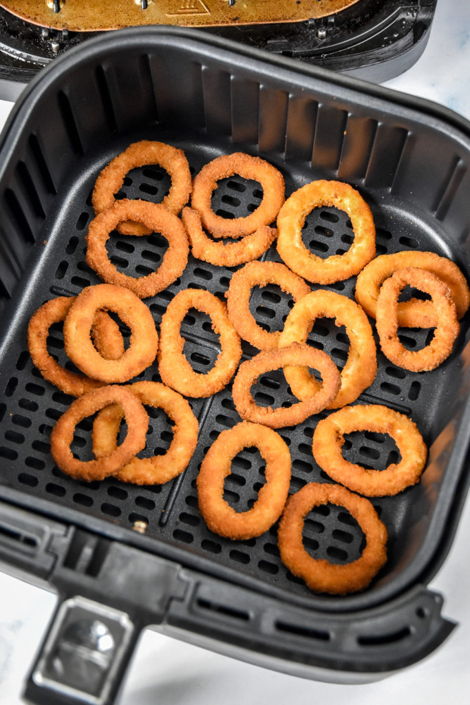 cook frozen foods in an air fryer like these onion rings in an air fryer basket.