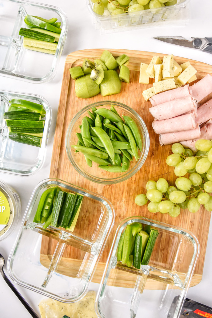 top down view of assembling the green food lunch box meal prep.