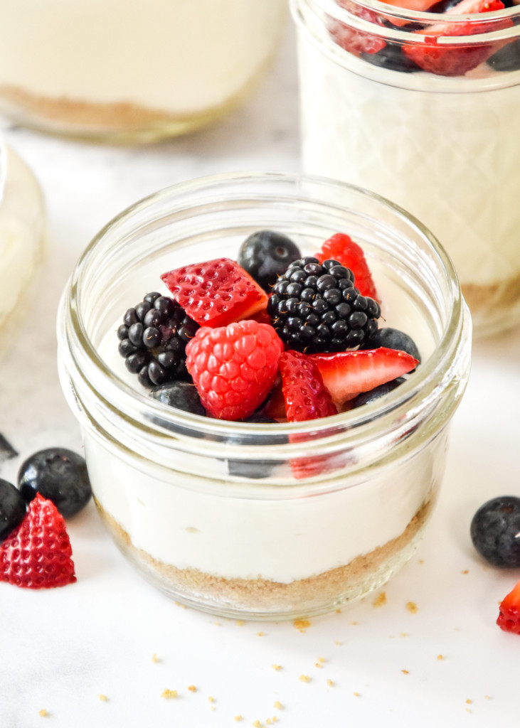 jar of no-bake cheesecake greek yogurt with berries on top.