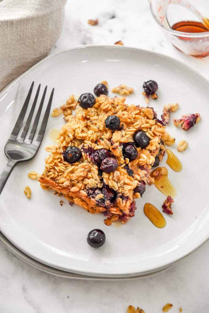 a serving of easy blueberry lemon baked oatmeal on a plate with a fork.