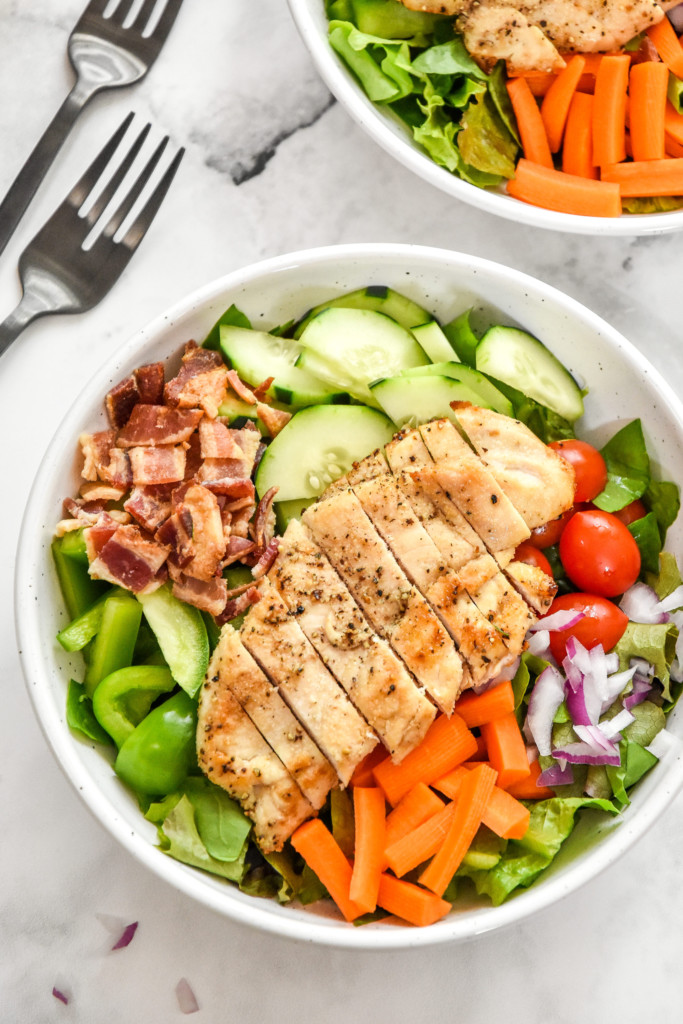 a prepped chicken bacon ranch salad in a bowl without dressing.