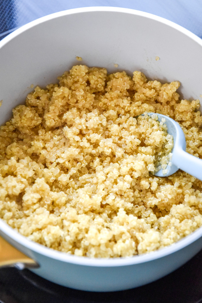 cooked quinoa in a pan with a spoon.
