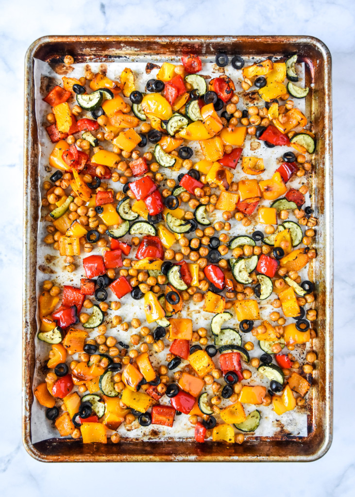 roasted veggies on a sheet tray for the mediterranean inspired grain bowl meal prep.