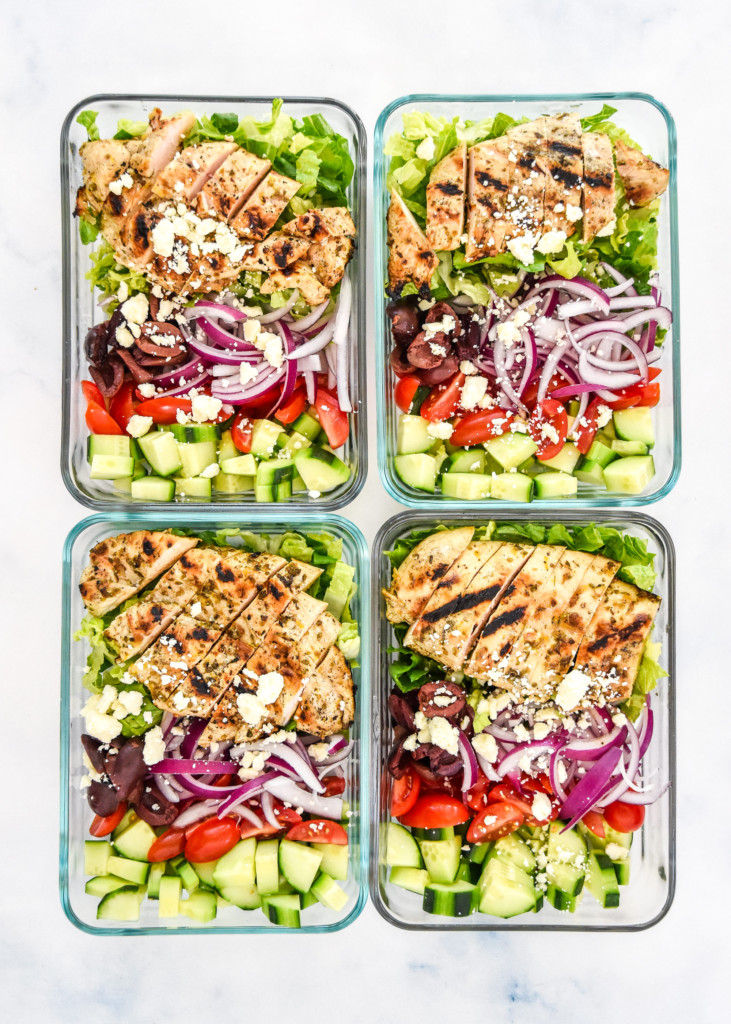 greek chicken salad meal prep in four glass meal prep containers.