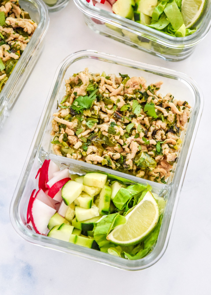 thai chicken larb inspired meal prep in a glass container with veggies.