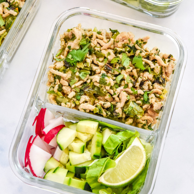 thai chicken larb inspired meal prep in a glass container with veggies.