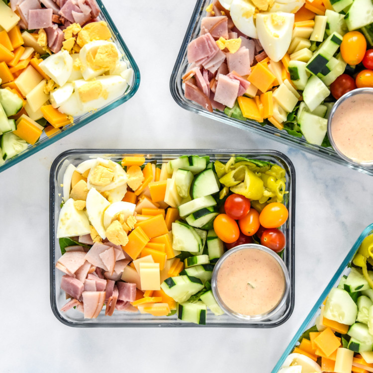 easy chef salad meal prep with dressing in rectangular glass containers.