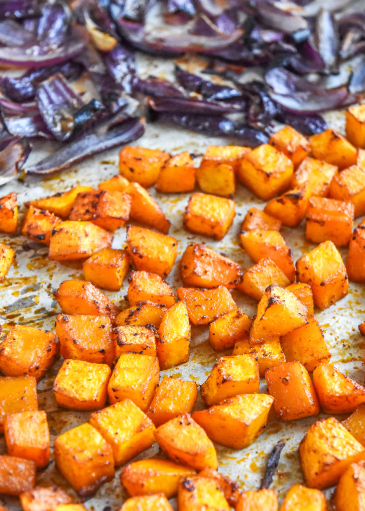 cooked cubed butternut squash on a sheet pan.