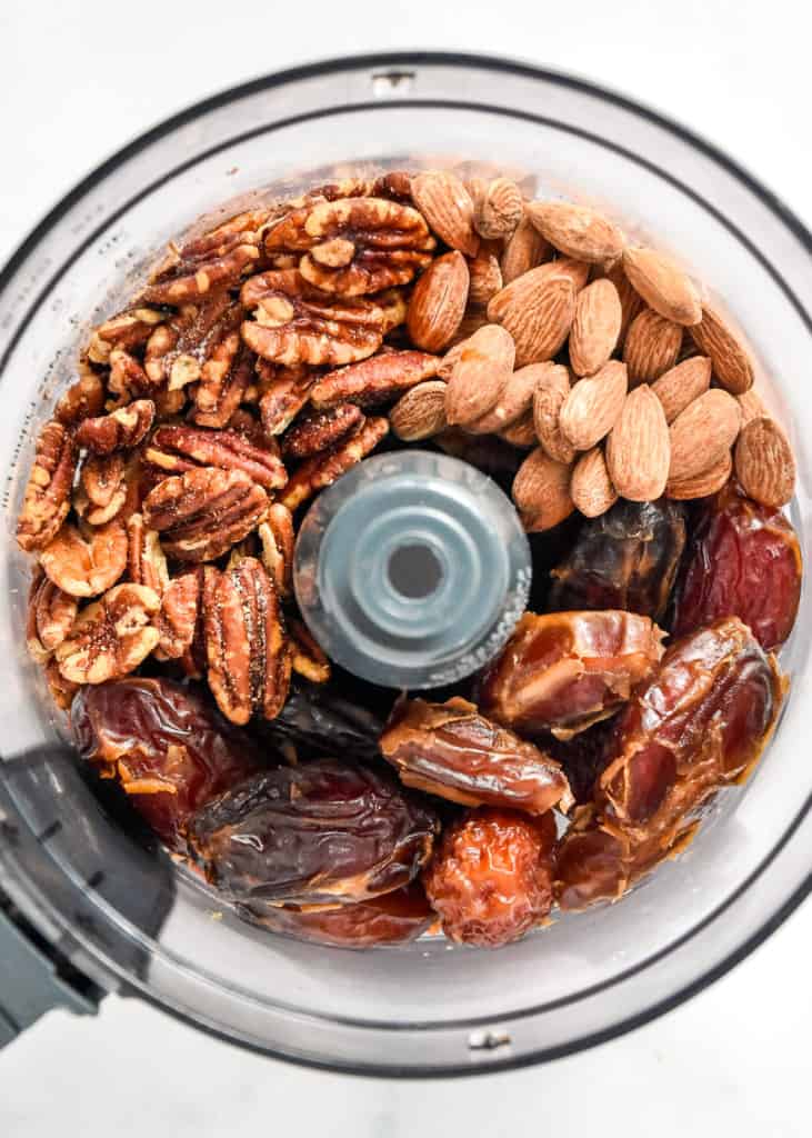 ingredients to make the no-bake pecan pie date balls in the food processor before blending.
