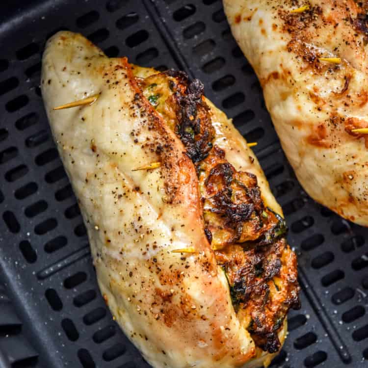 cooked air fryer stuffed chicken breast in the air fryer basket.