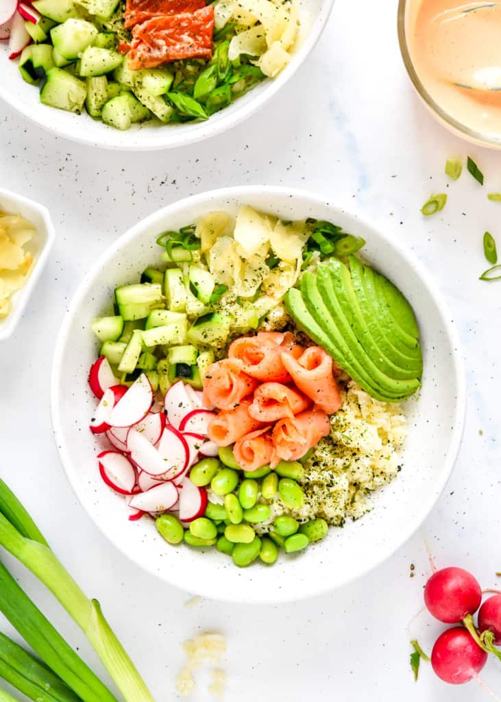 easy smoked salmon rice bowls with edamame, avocado, cucumbers and radishes.