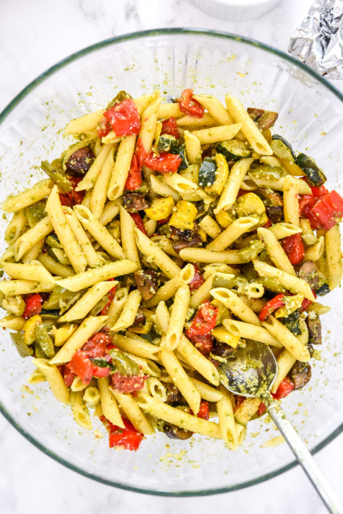 mixed roasted veggie pesto pasta in a large mixing bowl. 