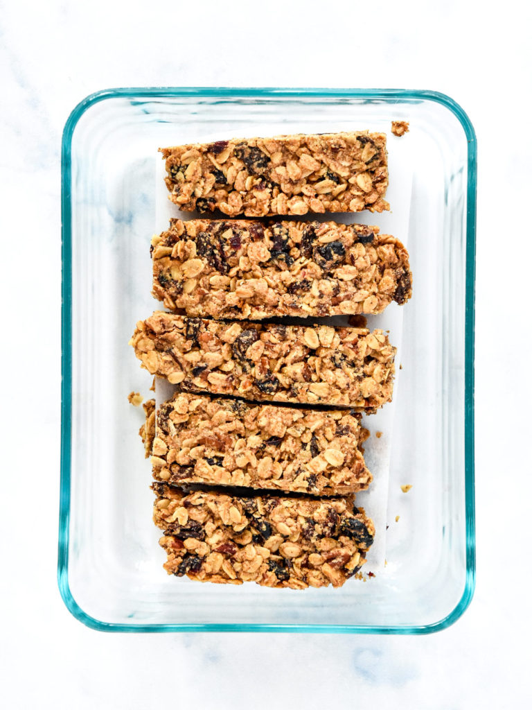 chewy cinnamon granola bars in a glass meal prep container.