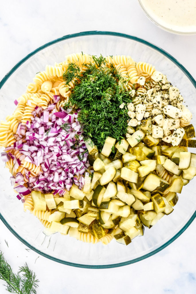 pickles, red onion, dill, feta and cooked pasta in a large bowl.