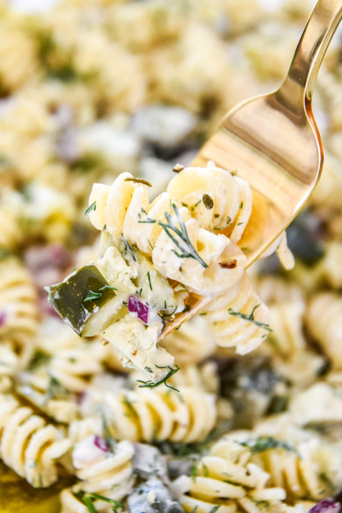 a forkful of creamy dill pickle pasta salad.